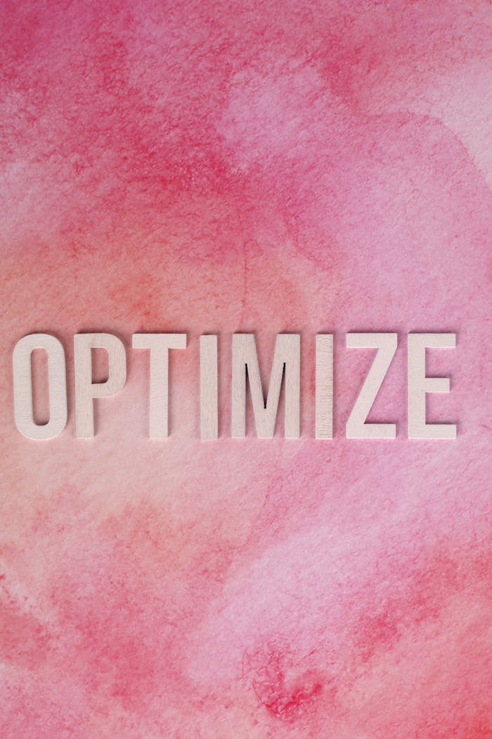 about-01 Inspirational 'Optimize' text on a pink watercolor background for creative projects.